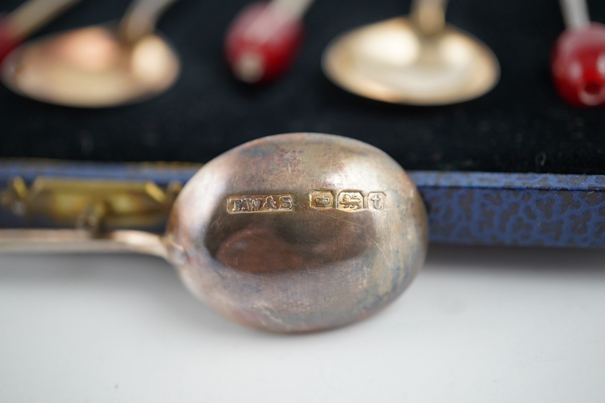 An Edwardian silver miniature articulated model spinning wheel, by Deakin and Francis Ltd, Birmingham 1905, 8.5cm and a cased set of coffee spoons, Sheffield 1936, with ‘bean’ terminals. Condition - fair